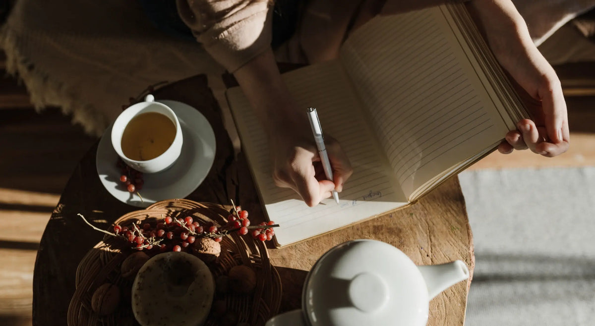  A person journaling at a wooden desk in morning light — Mind's Eye microdosing practice method