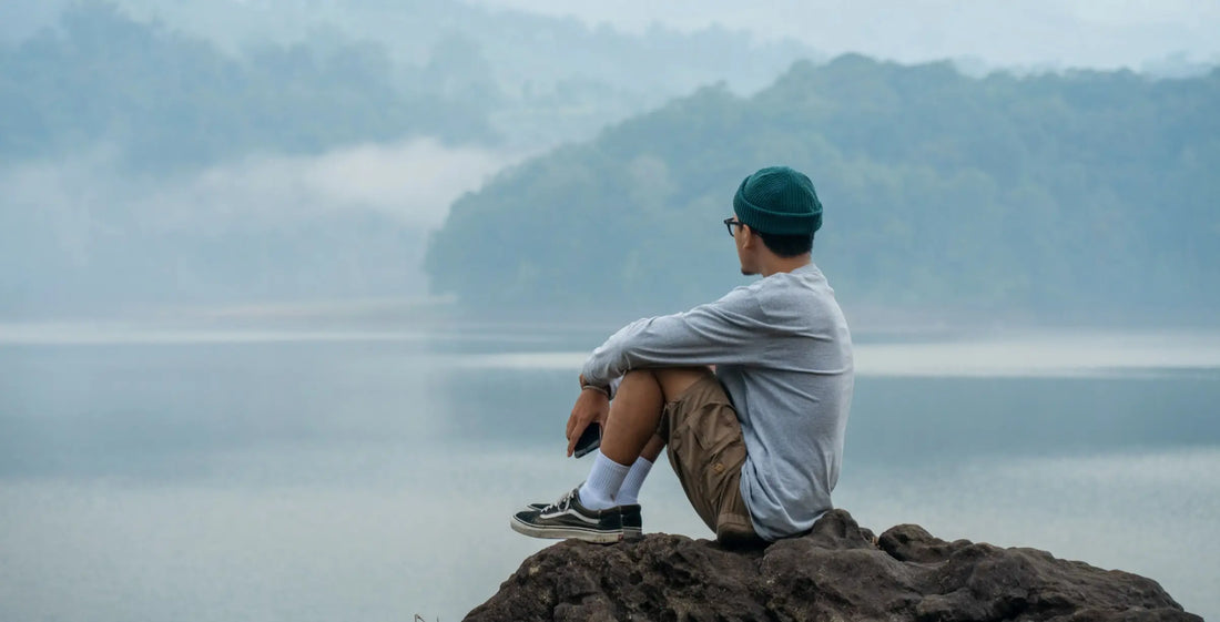  A person sitting alone in quiet reflection outdoors — microdosing inner work practice