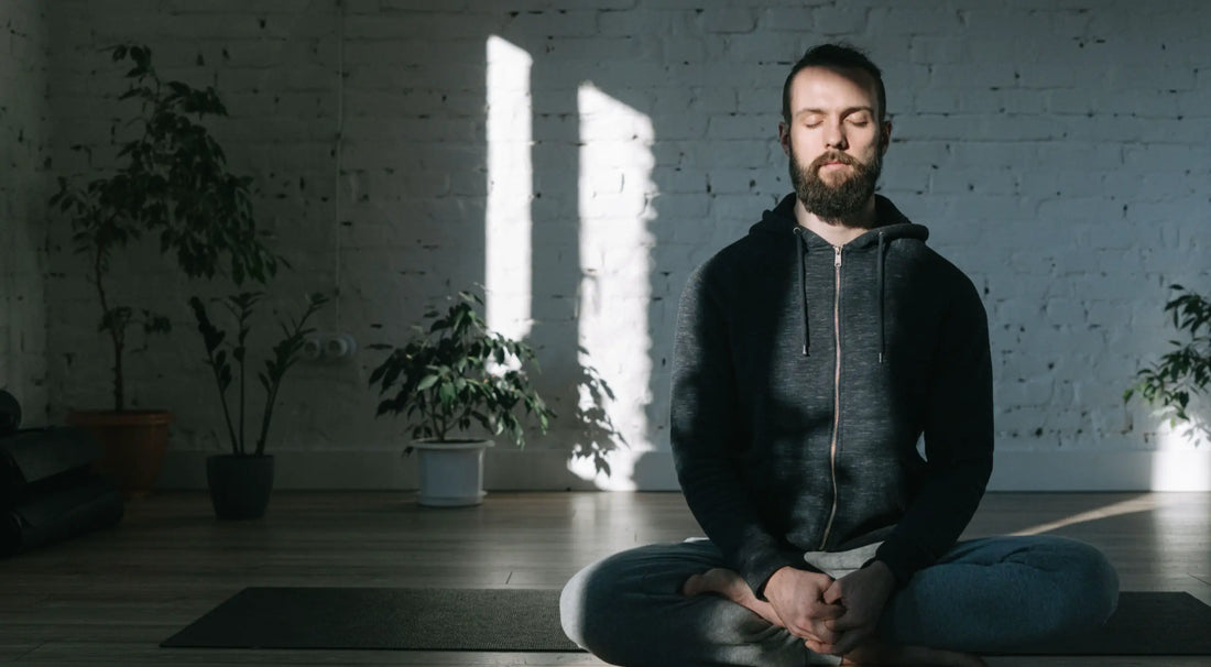 A person with eyes closed, calm breath, hands resting in lap — microdosing and intrusive thoughts guide