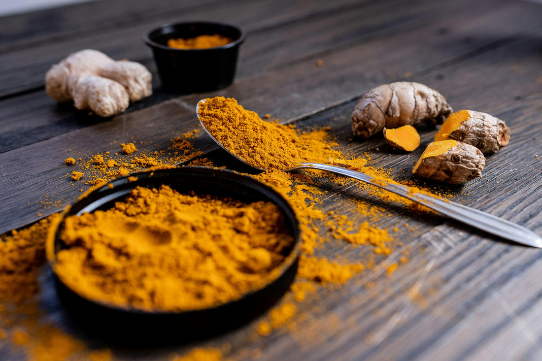 Fresh turmeric root and powder on white surface — vibrant golden orange | Medicine Box
