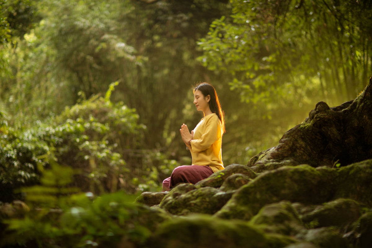 Woman meditating in soft morning light, representing mindful wellness in a Medicine Box blog